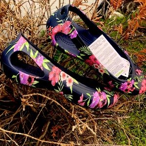A pair of new crocs kadee printed flat shoes